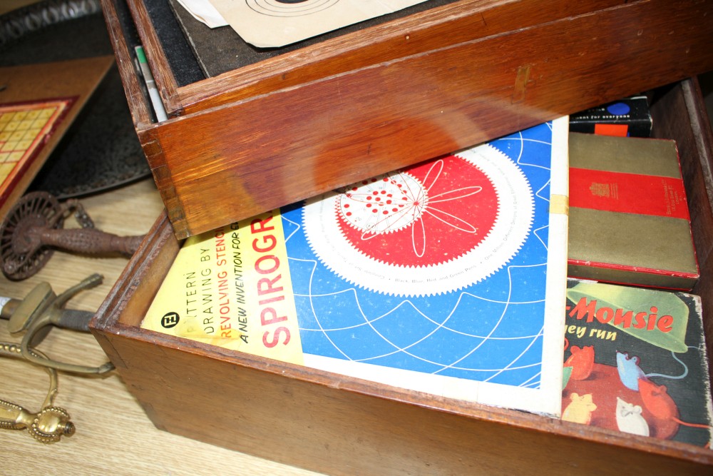 A quantity of assorted toys and games in a stacking three tier box